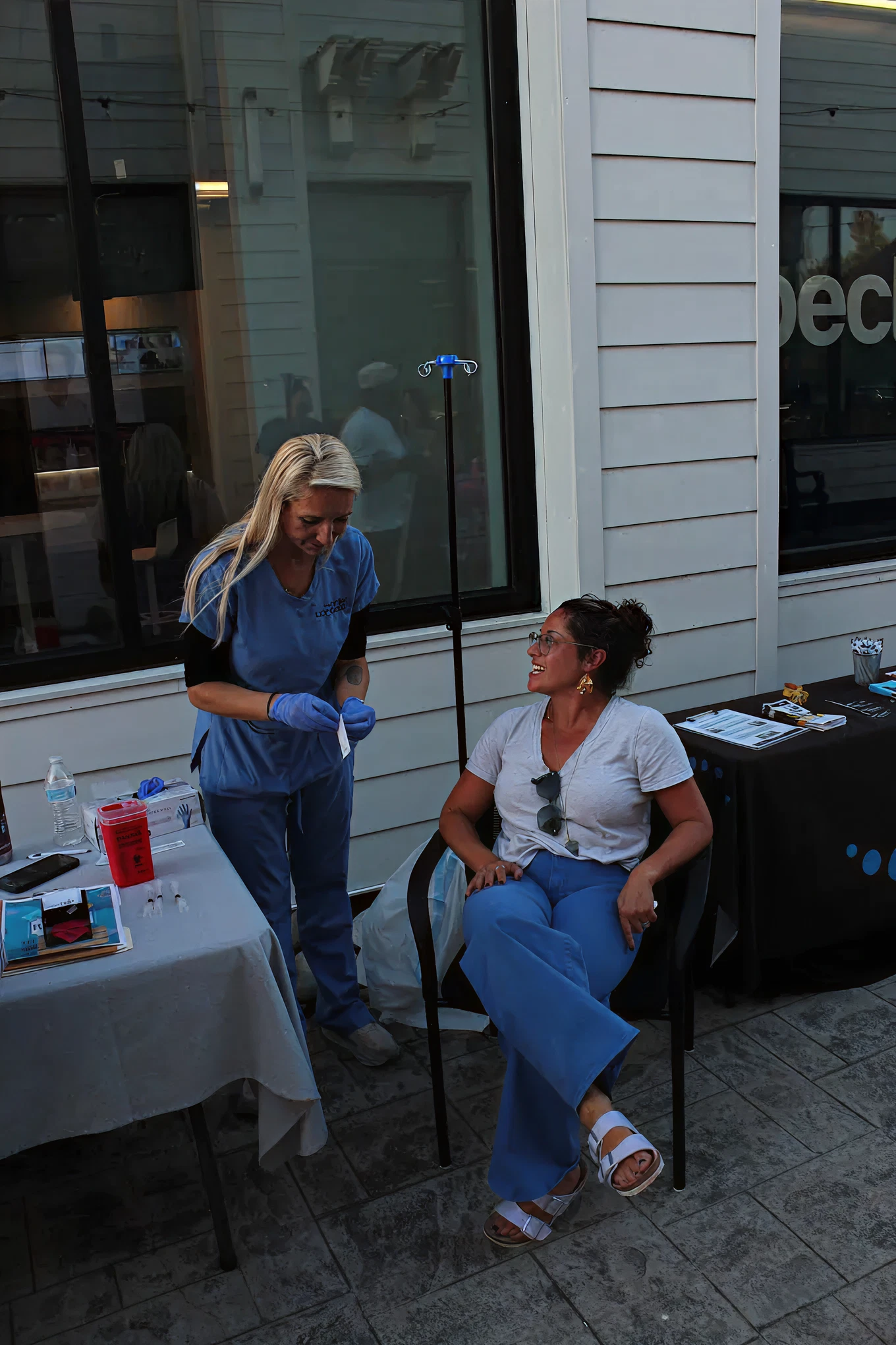 Clinician speaking with a seated patient during a treatment visit